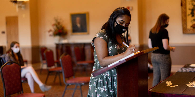 A student signing her name