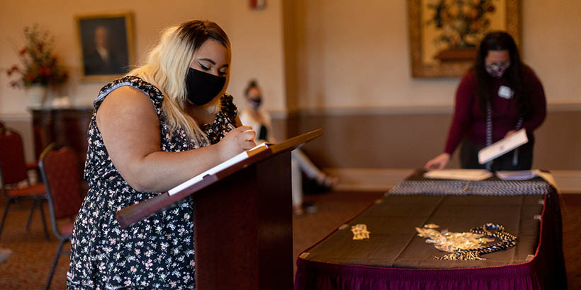 Student signing her name