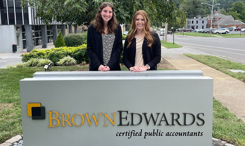 Two women posing with Brown Edwards sign