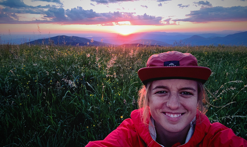 Selfie in the mountains with sunrise in background