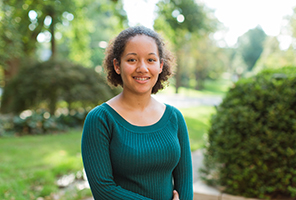 woman smiling outdoors on campus