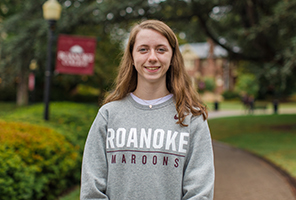 woman smiling outdoors on campus