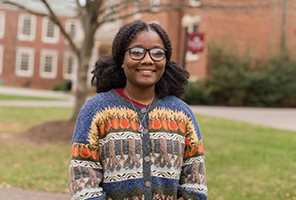 woman smiling outdoors on campus