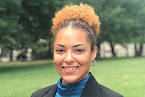 woman smiling outdoors on campus