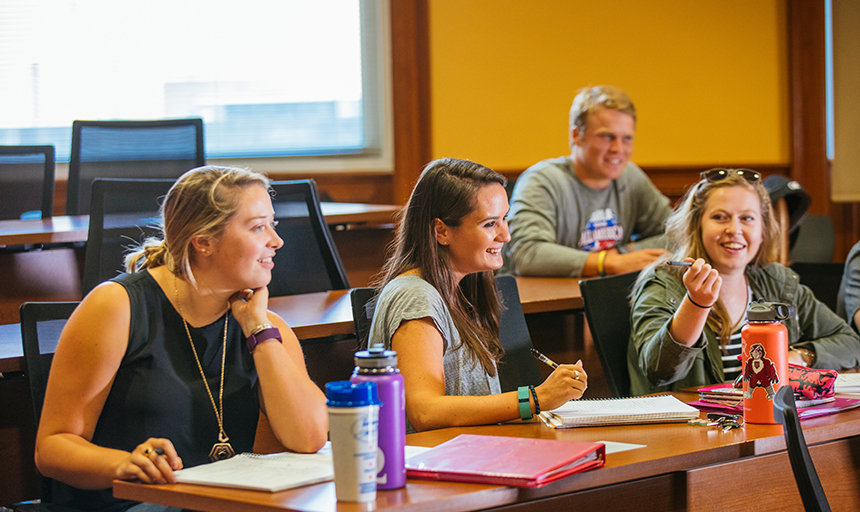 Students in classroom smiling