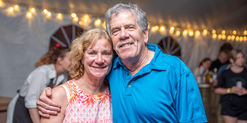 2 people stand together and smile for the camera