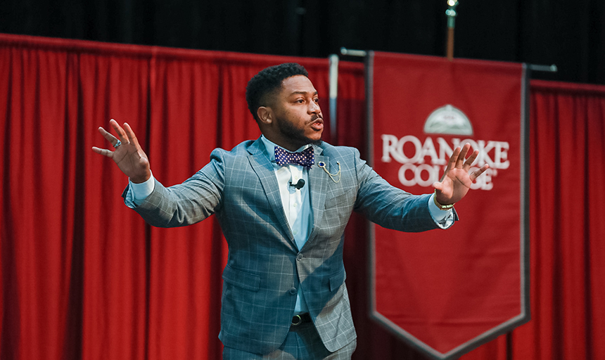 Brandon P. Fleming speaks in front of Roanoke College banner