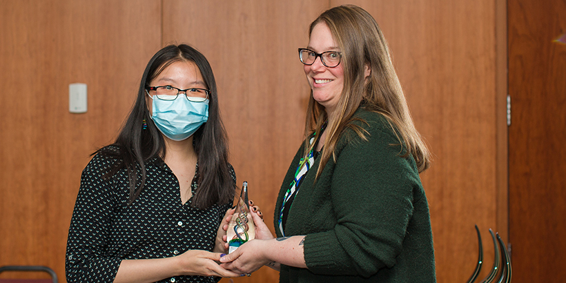 Two women holding award