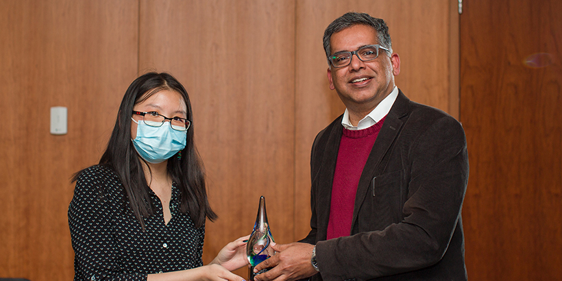 woman and man holding award