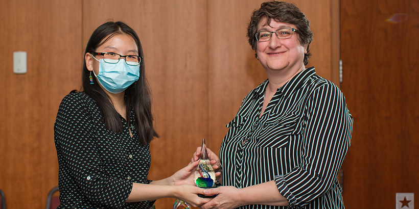 two people holding award