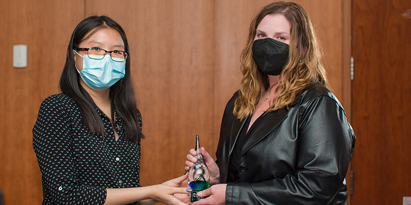 two people holding award