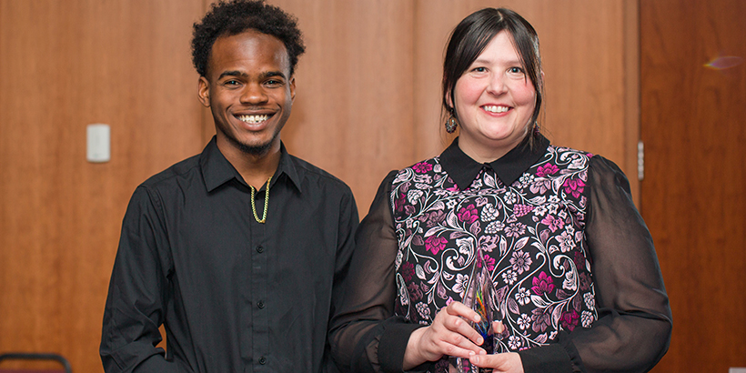 two people holding award