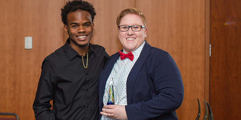 two people holding award