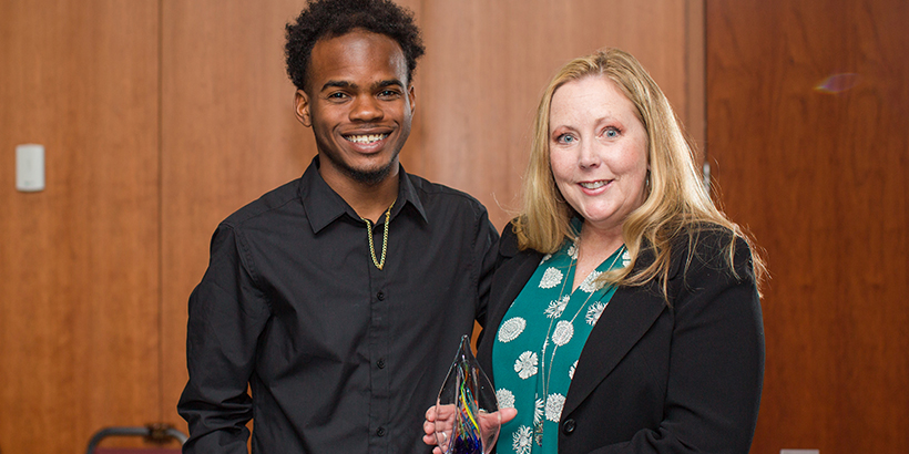 two people holding award