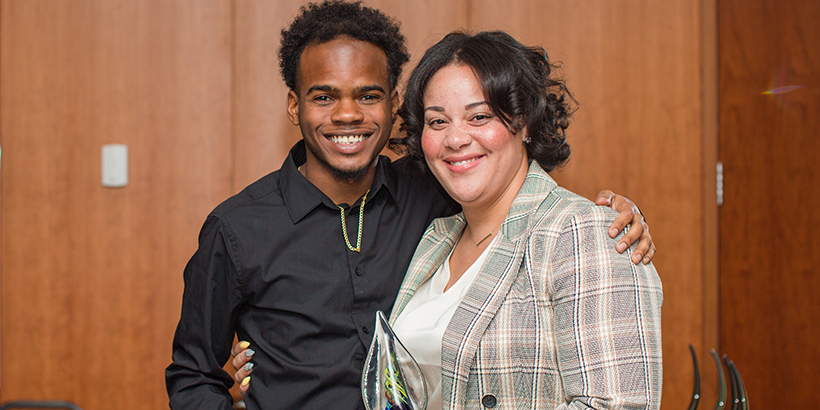 two people holding award