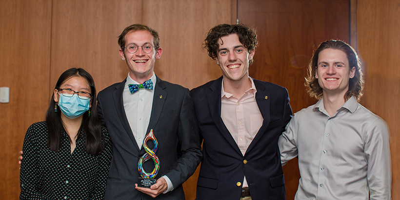 four people holding award