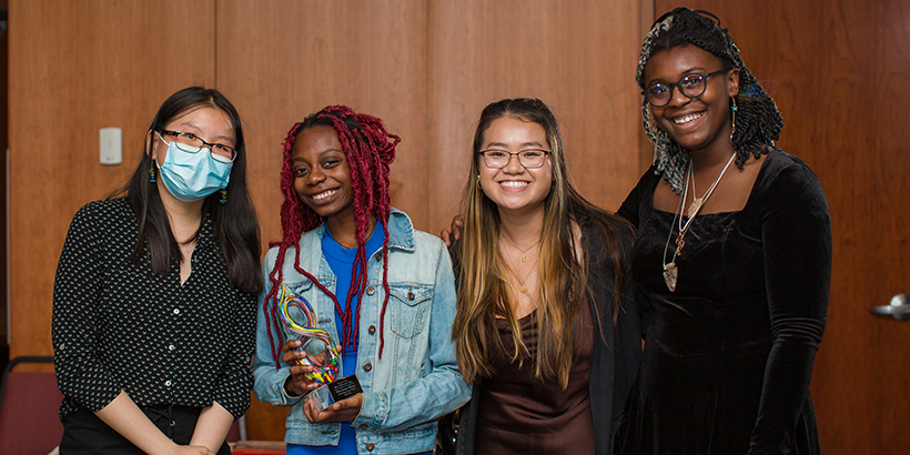 four people holding award