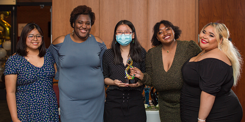 five people holding award