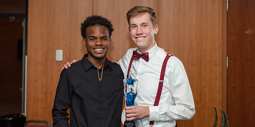 two people holding award