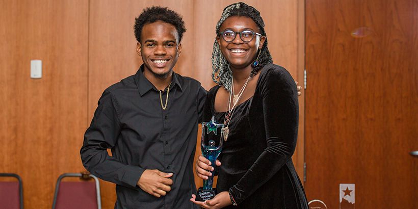 two people holding award