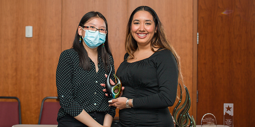 two people holding award