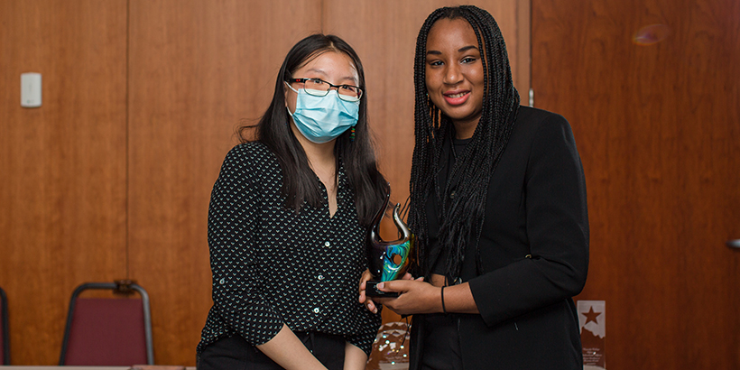 two people holding award