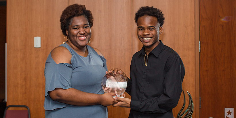 two people holding award