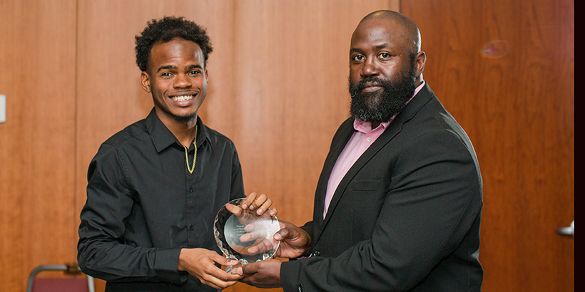 two people holding award