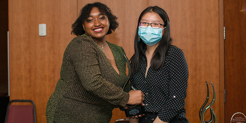 two people holding award