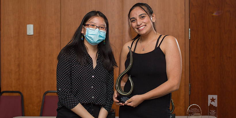 two people holding award