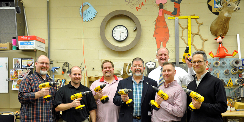 George Arthur with other men all holding power drills