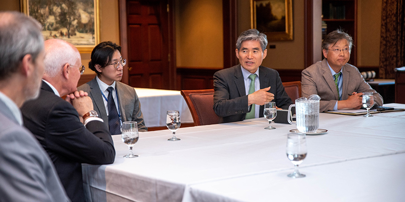 Men talk around a table