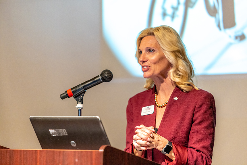 woman speaks at podium