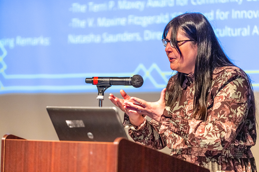 woman speaks at podium