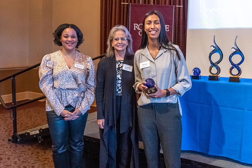 three women pose with award