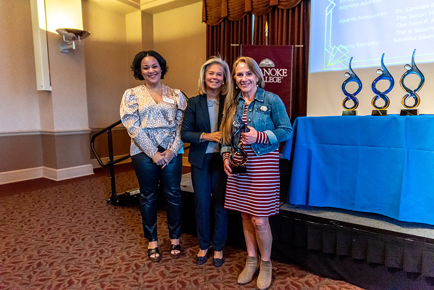 three women pose with award