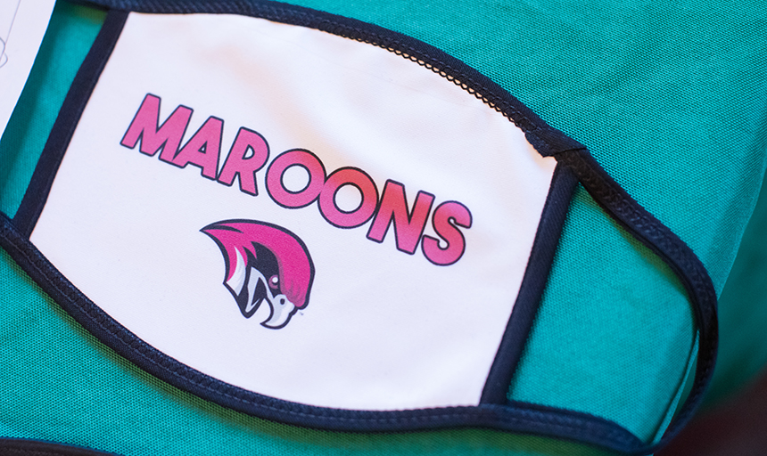 face mask with Maroons logo on it