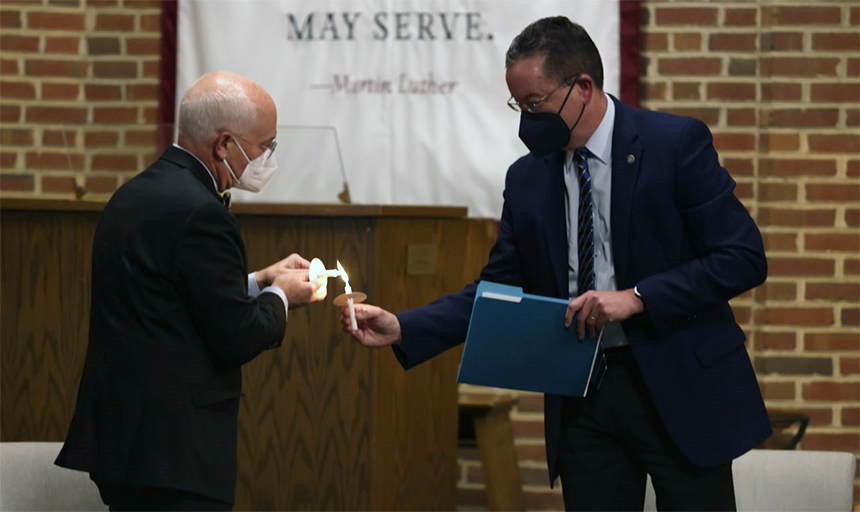 President Maxey and Dean Rambo light candles in chapel