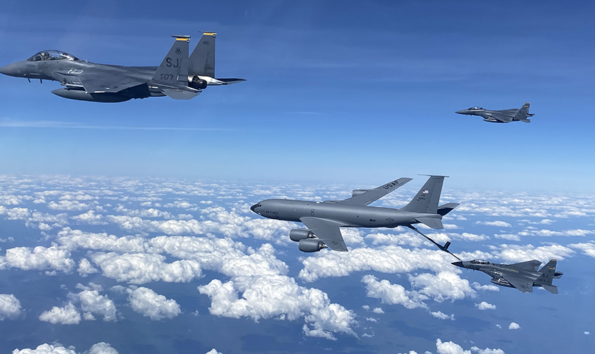 Military planes flying above the clouds