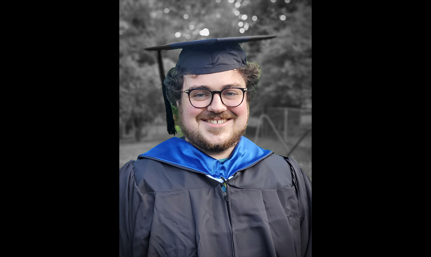 Samuel Paitsel in cap and gown at graduation