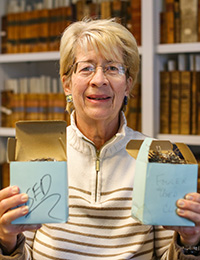 Linda Miller with bookshelves behind her