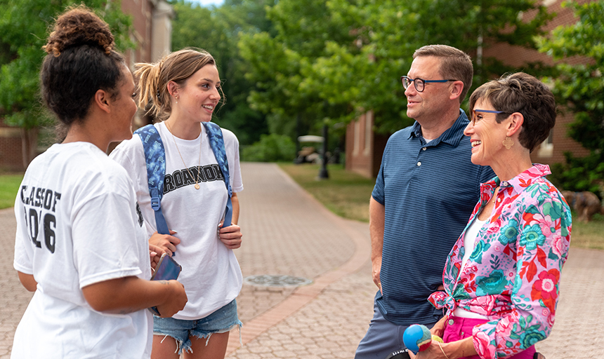 The Shushoks chat with students during summer orientation in August.