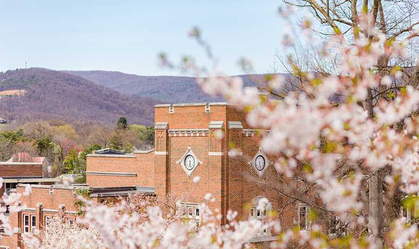 Alumni Gym in spring with mountains in background