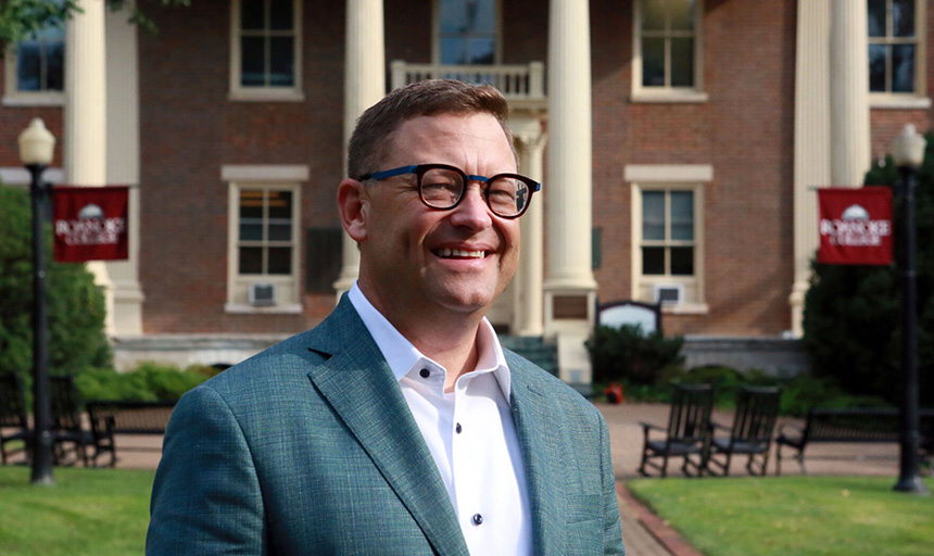 President Frank Shushok stands in front of Administration Building