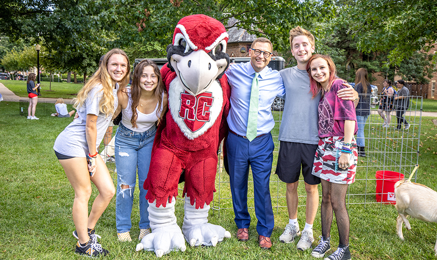Shushok poses with Rooney and students during Friday on the Quad.