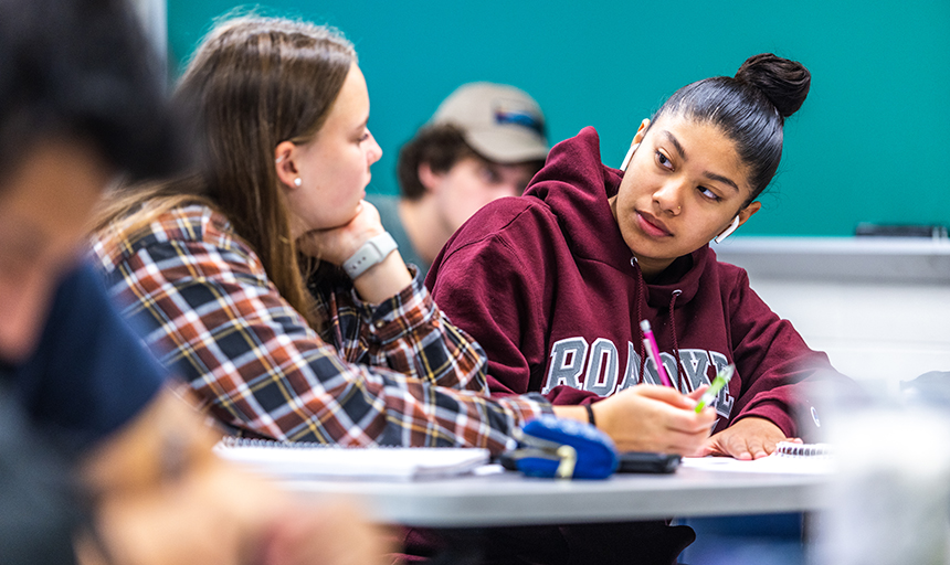 two students work together on a project in class