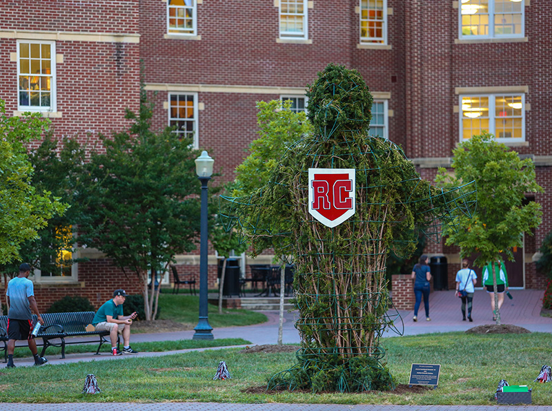picture of the rooney topiary with an RC logo sign hanging from its neck