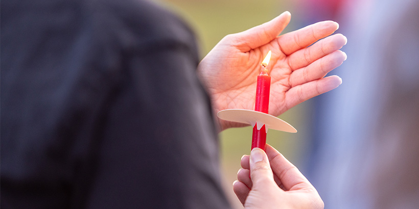 Closeup image of a candle lit during Sunday's vigil