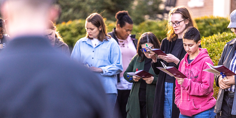 Students and faculty stand together and speak aloud the names of enslaved people with historical ties to Roanoke College