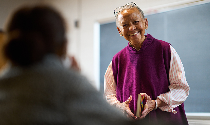 Nikki Giovanni in the classroom holding book 